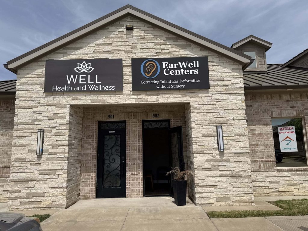 Stone building entrance with EarWell Centers signage in McKinney